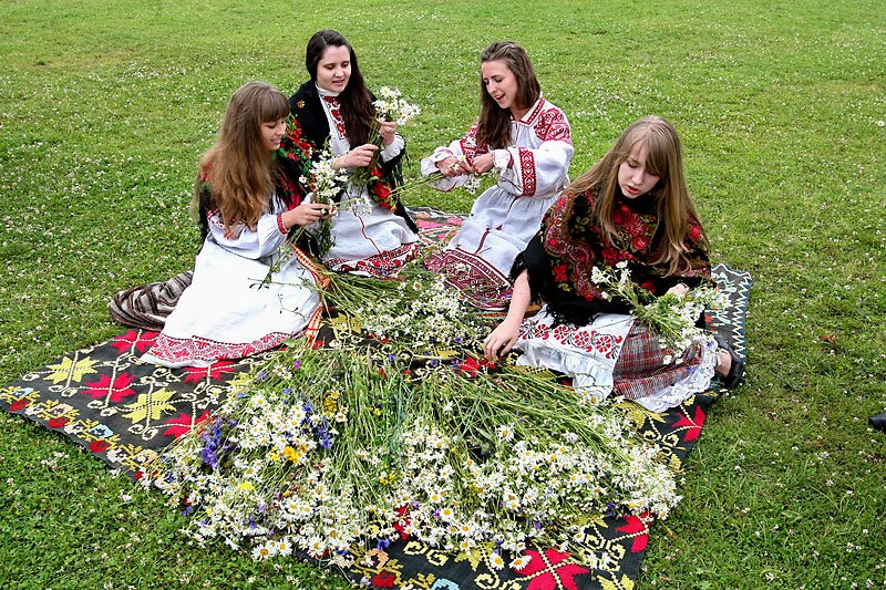 Belarusian girls steal make beautiful wreaths from flowers of the field before Kupalle to ask the fate about their betrothed ones